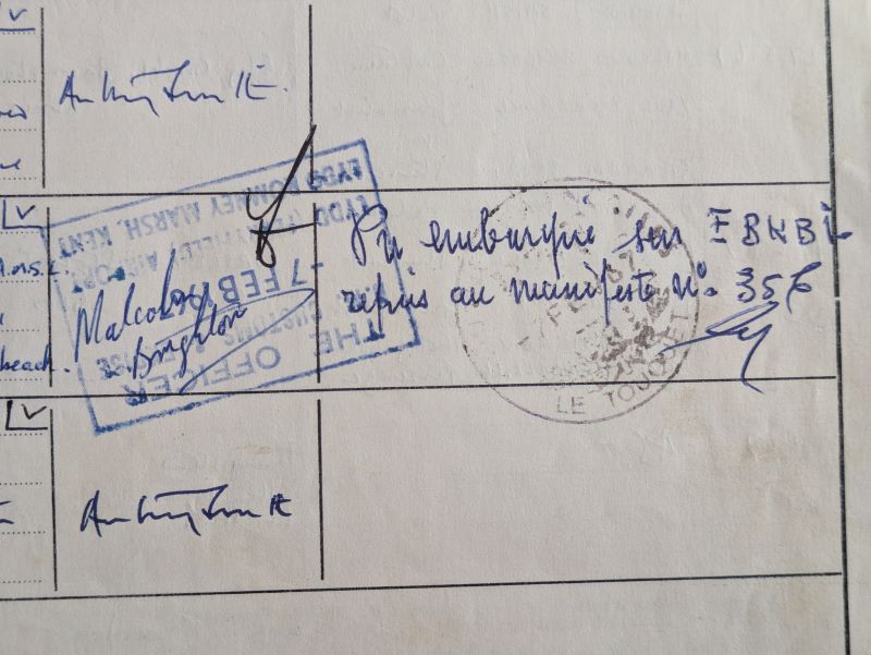 Picture of entry in a logbook showing rubber stamp and ink signatures